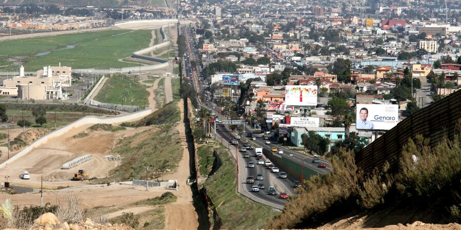 A small fence separates densely populated Tijuana, Mexico, right, from the United States in the Border Patrols San Diego Sector. Construction is underway to extend a secondary fence over the top of this hill and eventually to the Pacific Ocean.
