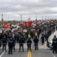 Protesters March Against Police While Officers Provide Close Escort